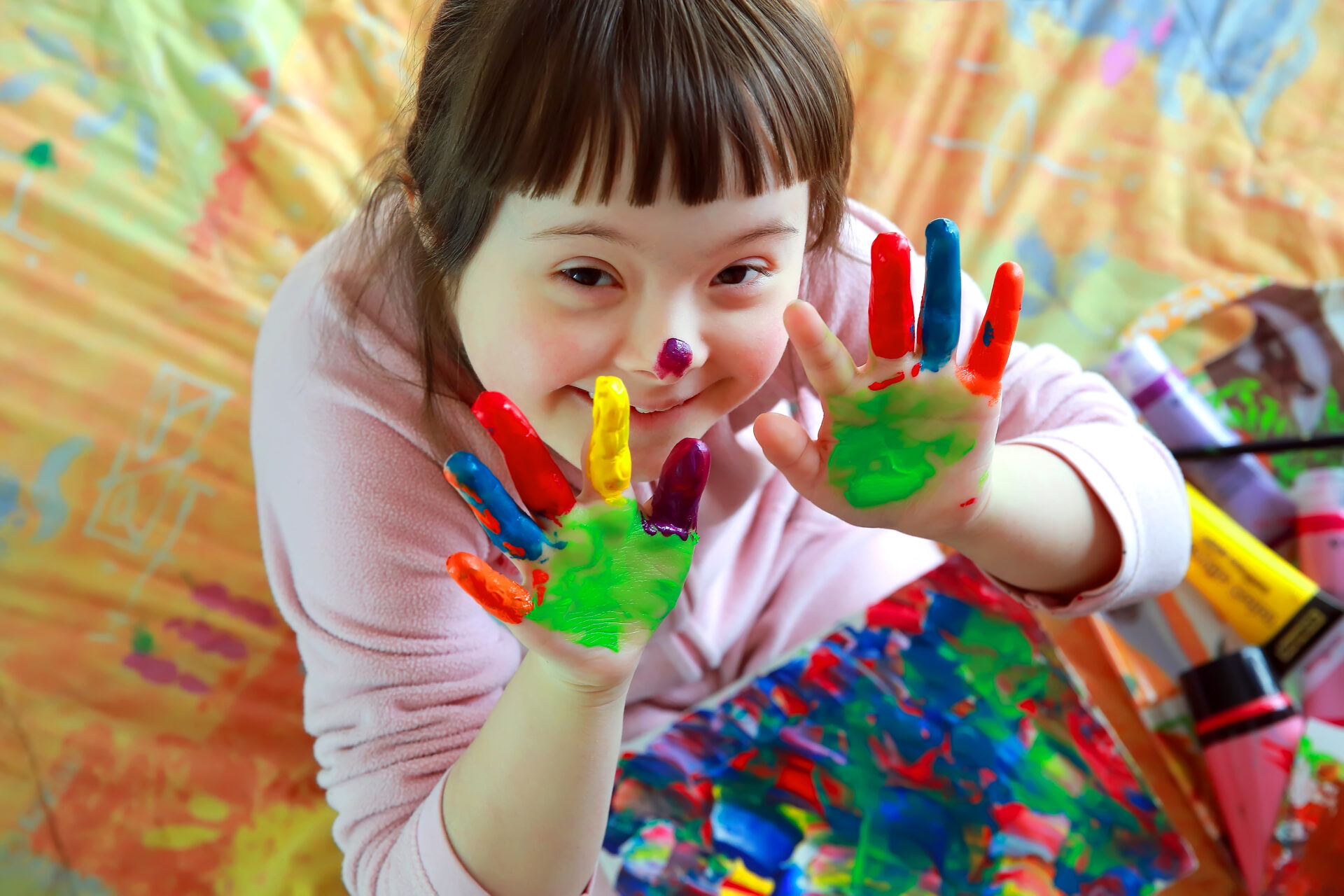 Cute little girl with painted hands.